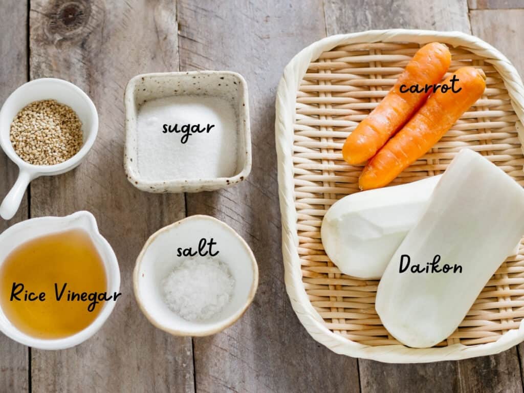 rice vinegar, sugar, salt, carrot and Daikon and sesame seeds