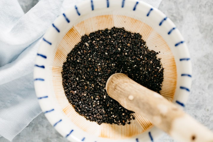 black sesame seeds in a Japanese mortar with a wooden pestle
