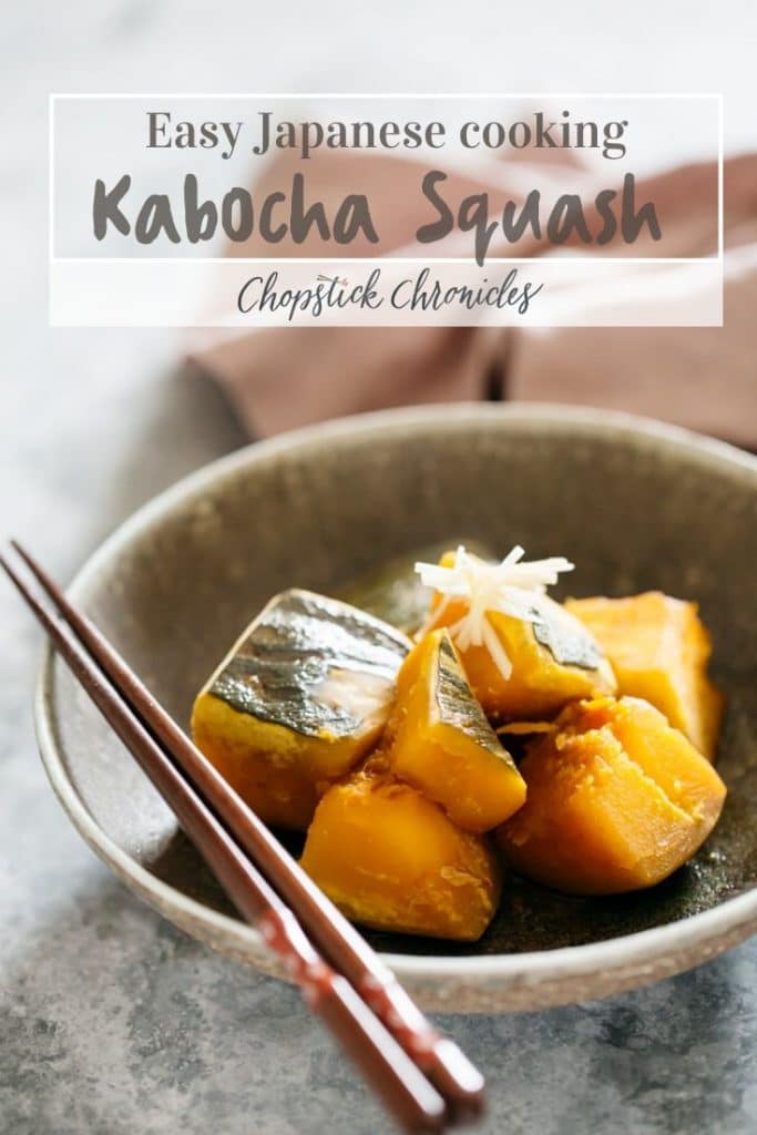 simmered kabocha squash served in a round shallow bowl with a pair of chopsticks