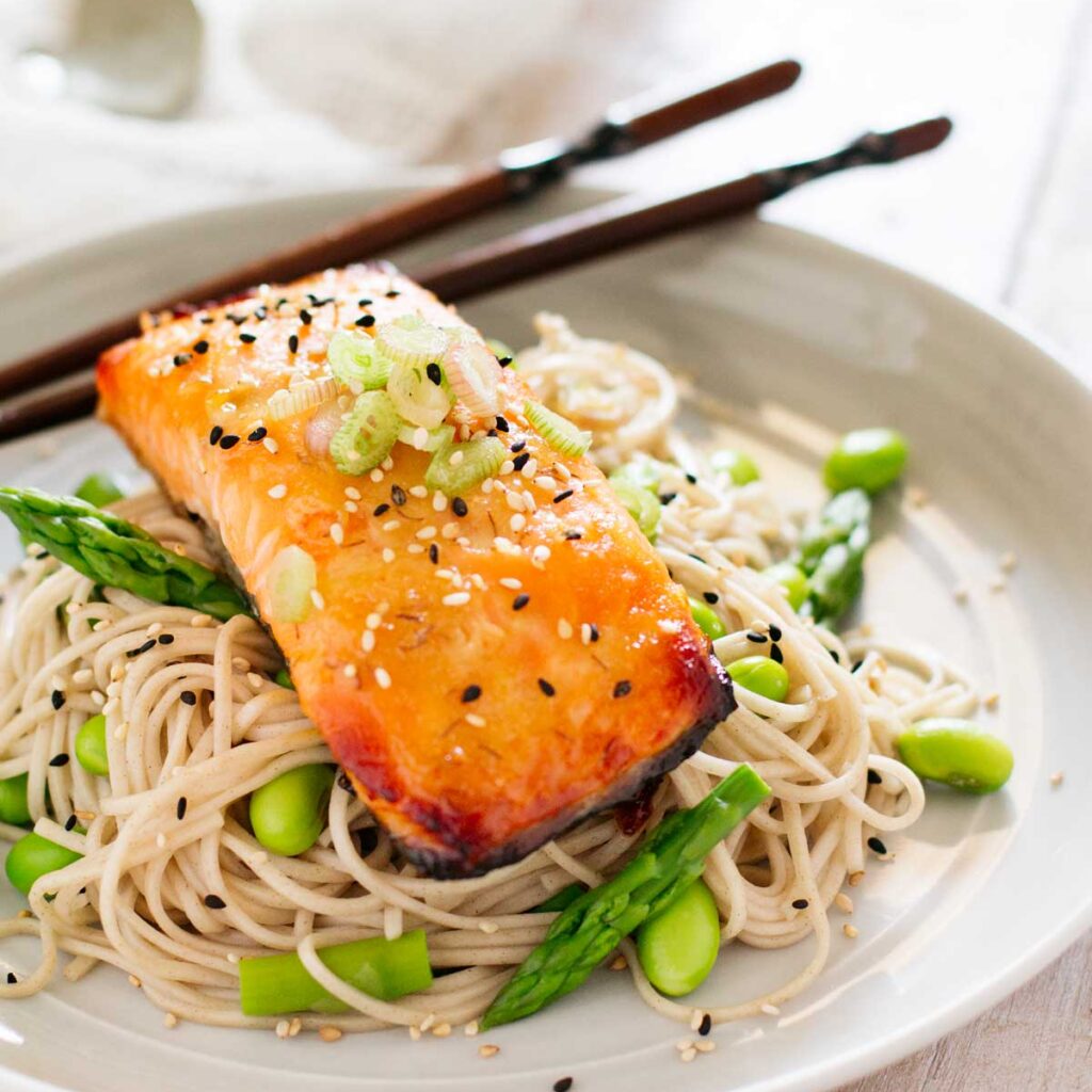 Miso glazed salmon served on soba noodles with edamame beans 