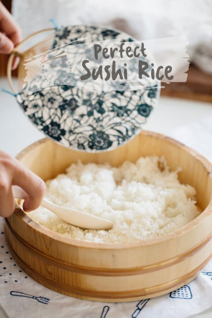Sushi rice in a wooden tub with Japanese fan
