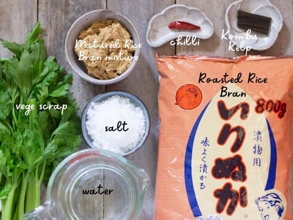 roasted rice bran packet, salt, water, matured rice bran mixture, a chilli, a strip of kombu kelp and vege scraps