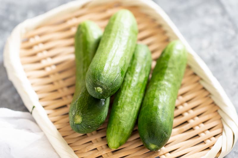 4 cucumbers on a bamboo tray