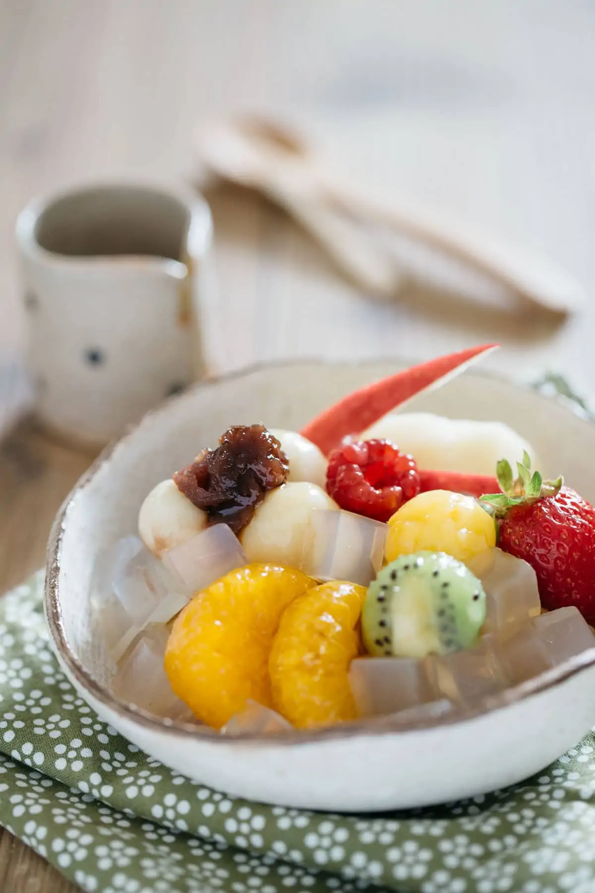 Anmitsu, Japanese cold dessert served in a small Japanese potter bowl with various fruit. mochi and azuki bean paste