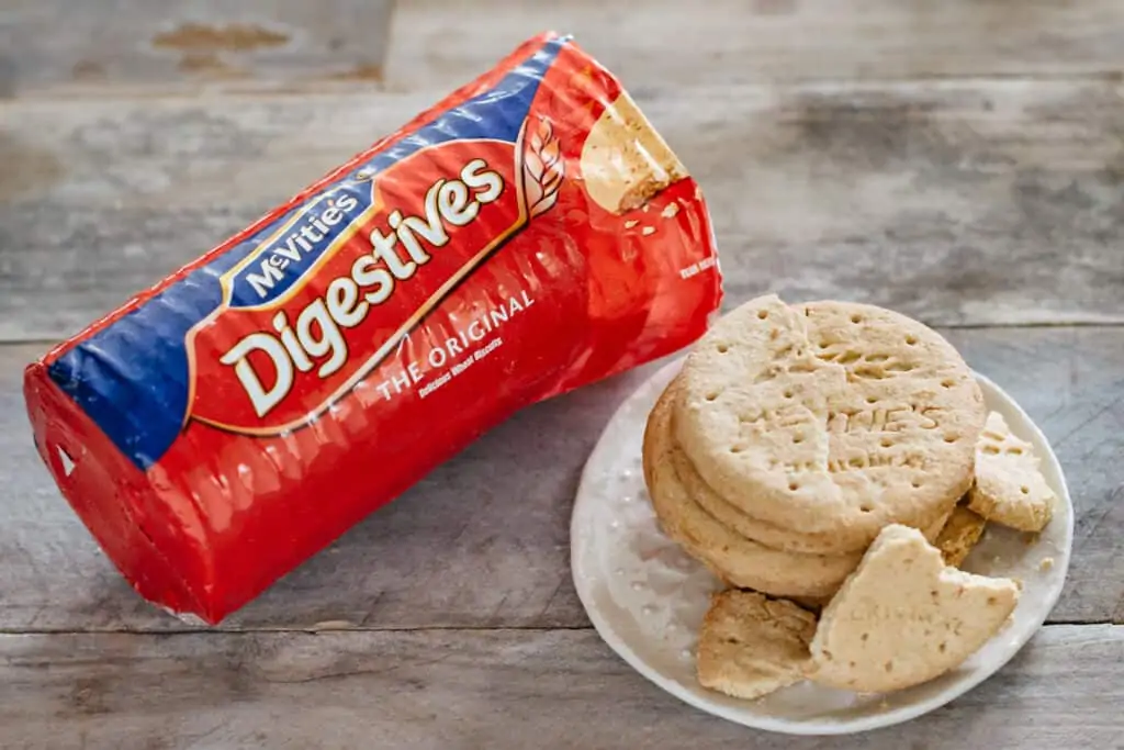 Mcvities digestives biscuits package and 6 biscuits on a small plate 