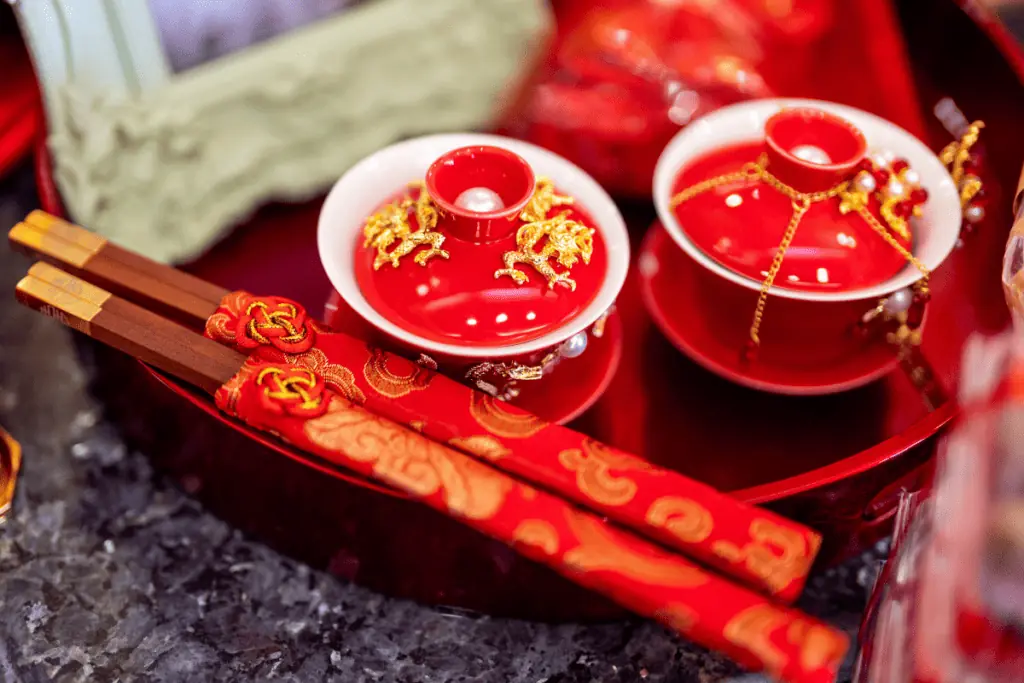 chinese chopsticks with two red bowls with lids