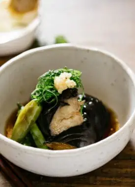 Japanese eggplant recipe agebitashi is served in a round shallow bowl
