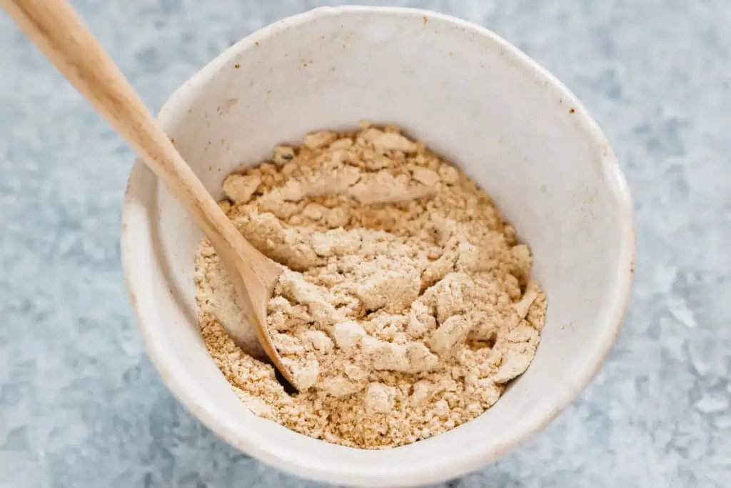 kinako soybean powder in a small bowl with a wooden spoon