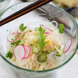 Somen noodles served in a glass bowl with a pair of chopsticks