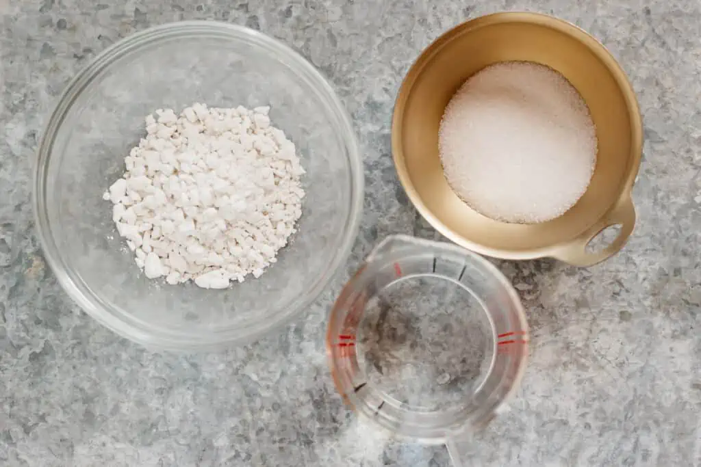 warabimochiko, sugar and water in bowls 
